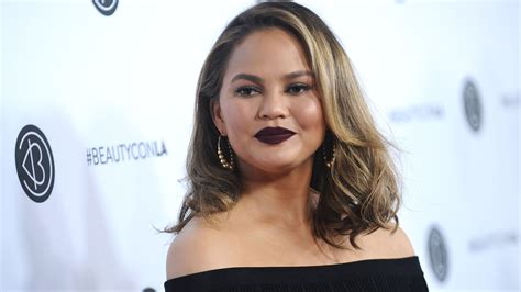 Chrissy Teigen Poses Topless on a Yacht With Rose Wine Bottle